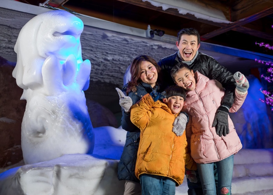 Family playing in the snow at Snow City Singapore